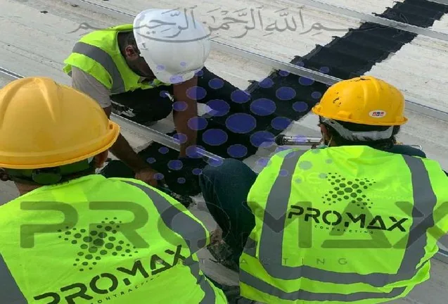 Promax team installing EPDM waterproofing on a metal roof in Dubai UAE