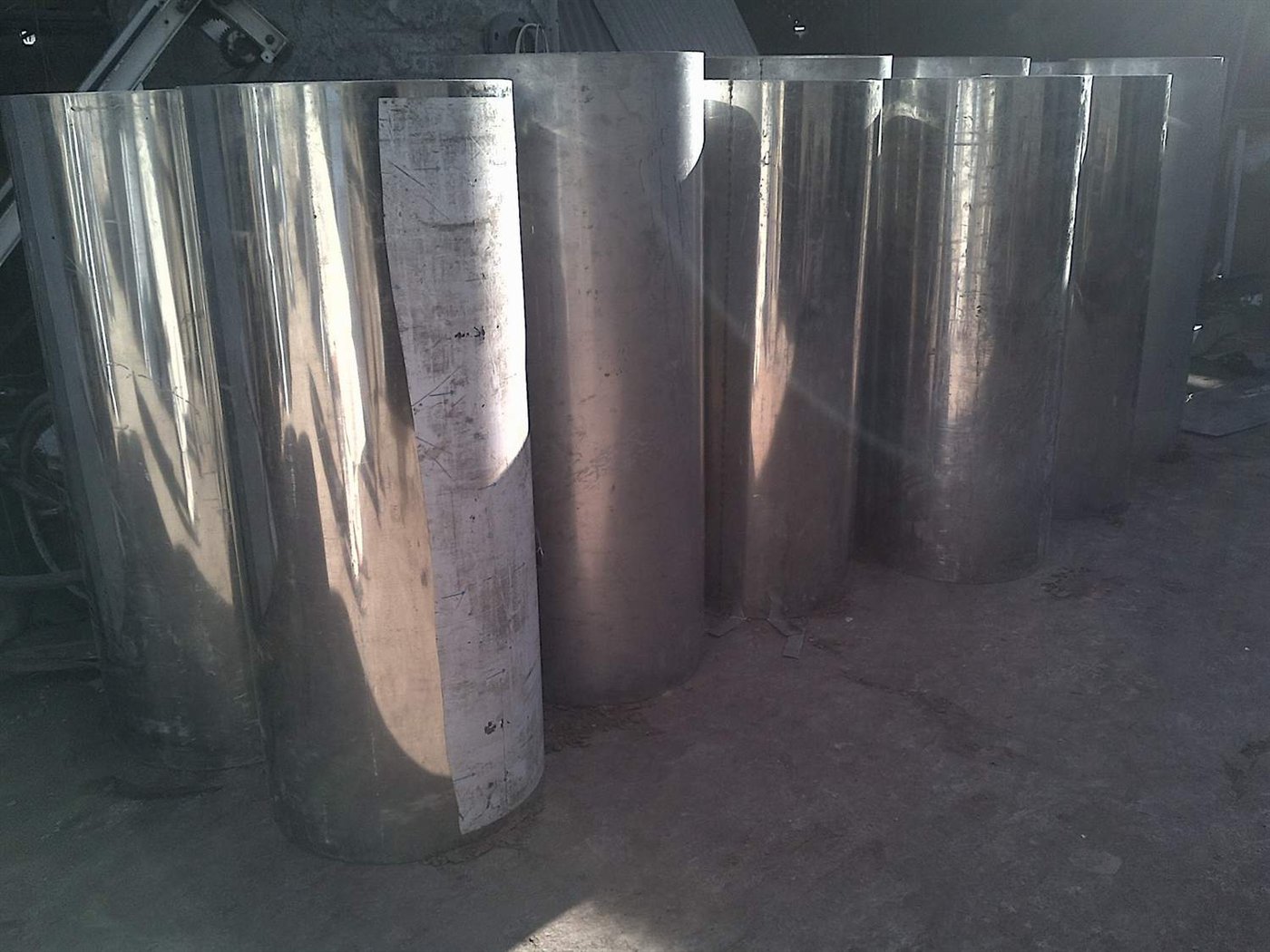 Rows of finished stainless steel linen chute barrels ready for supply and installation in Dubai UAE