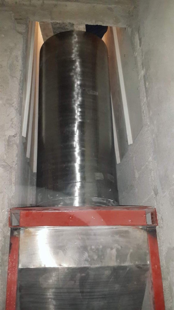 Stainless steel linen chute installed in a building shaft in the UAE